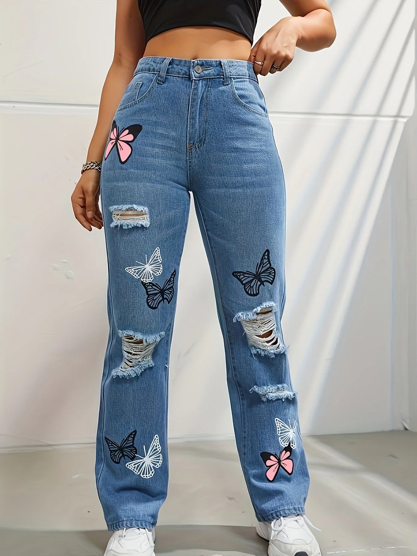 Women's high-waisted straight-leg jeans with butterfly print and distressed details