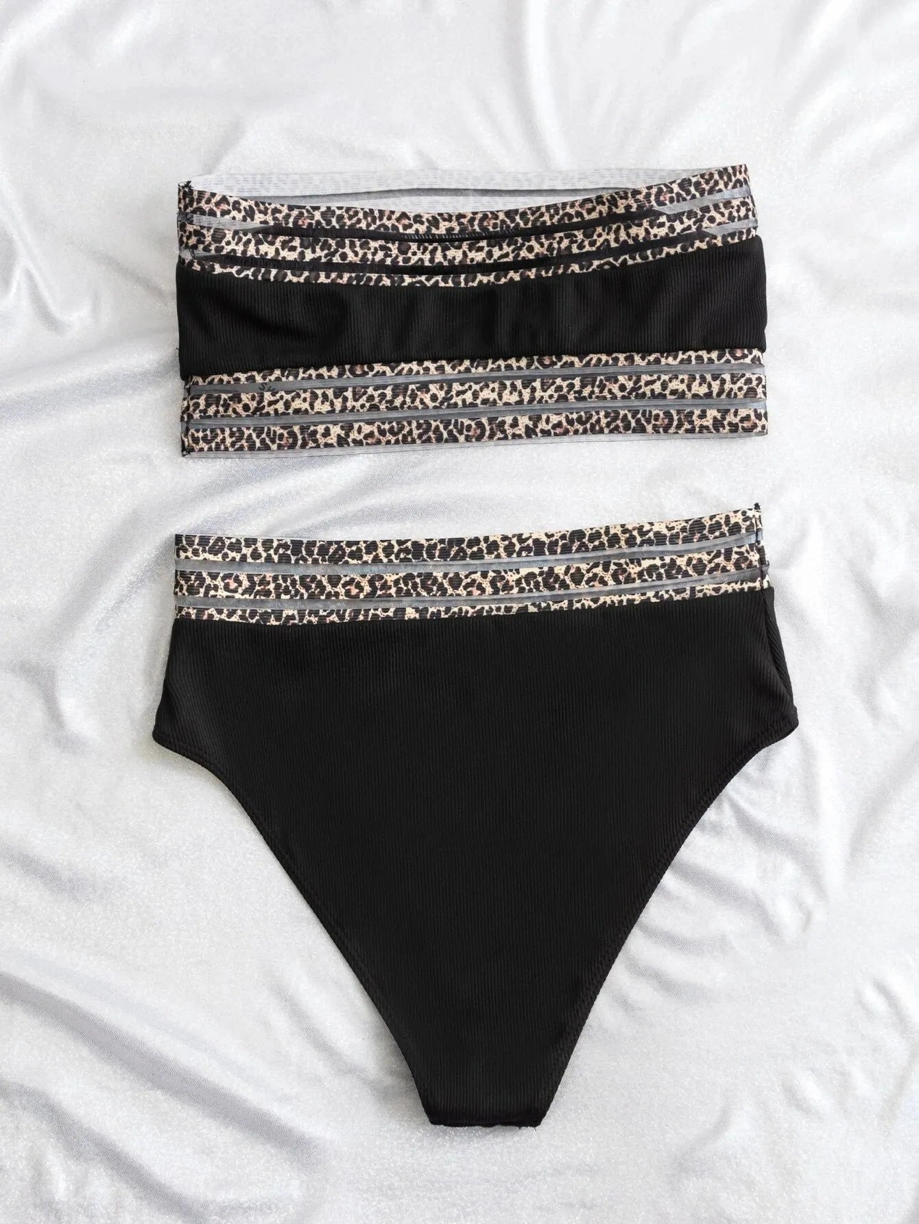 Black strapless bikini set with leopard print detail, showing separate bra and shorts.