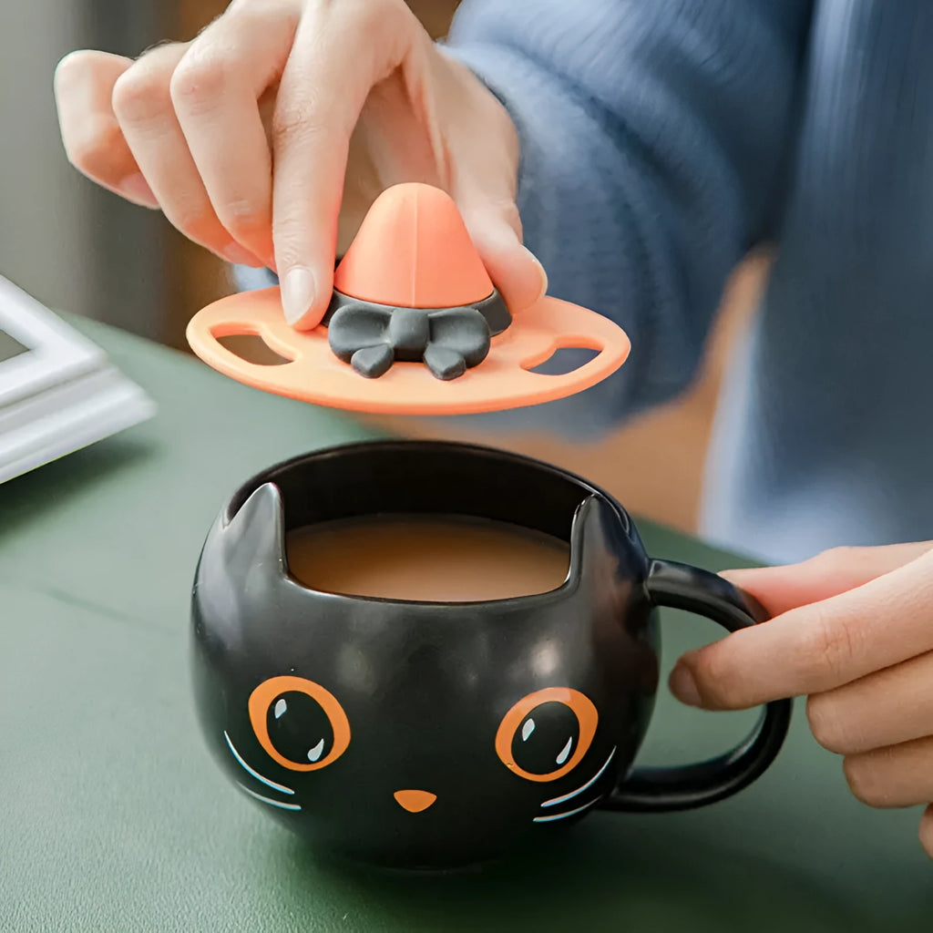 Black ceramic cat-shaped mug with pumpkin spoon couple design, 355ml capacity.