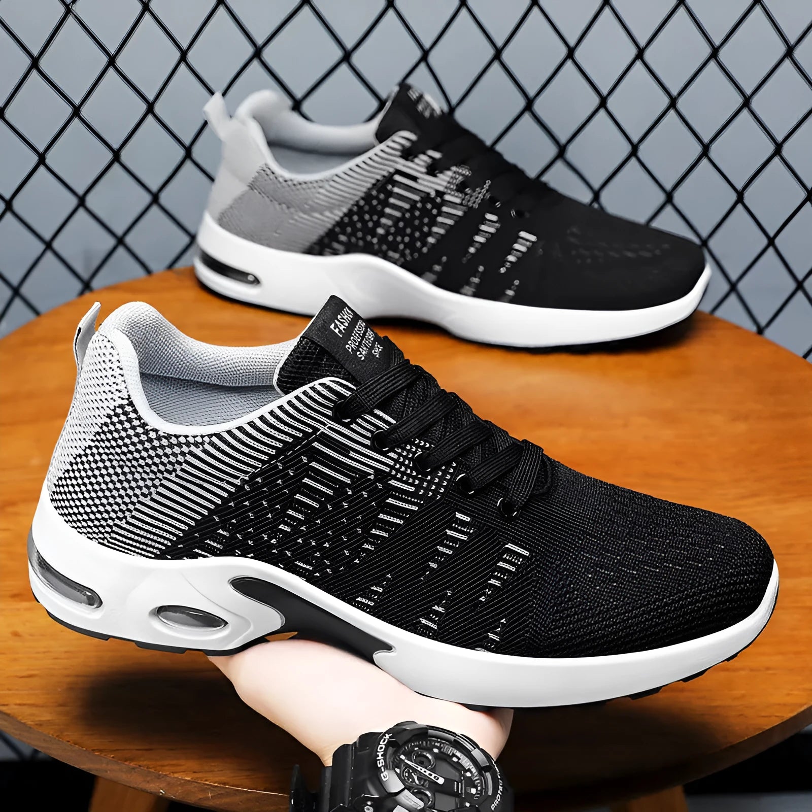 Men's low-top casual sneakers in black and blue with Flyknit mesh upper and flat sole.