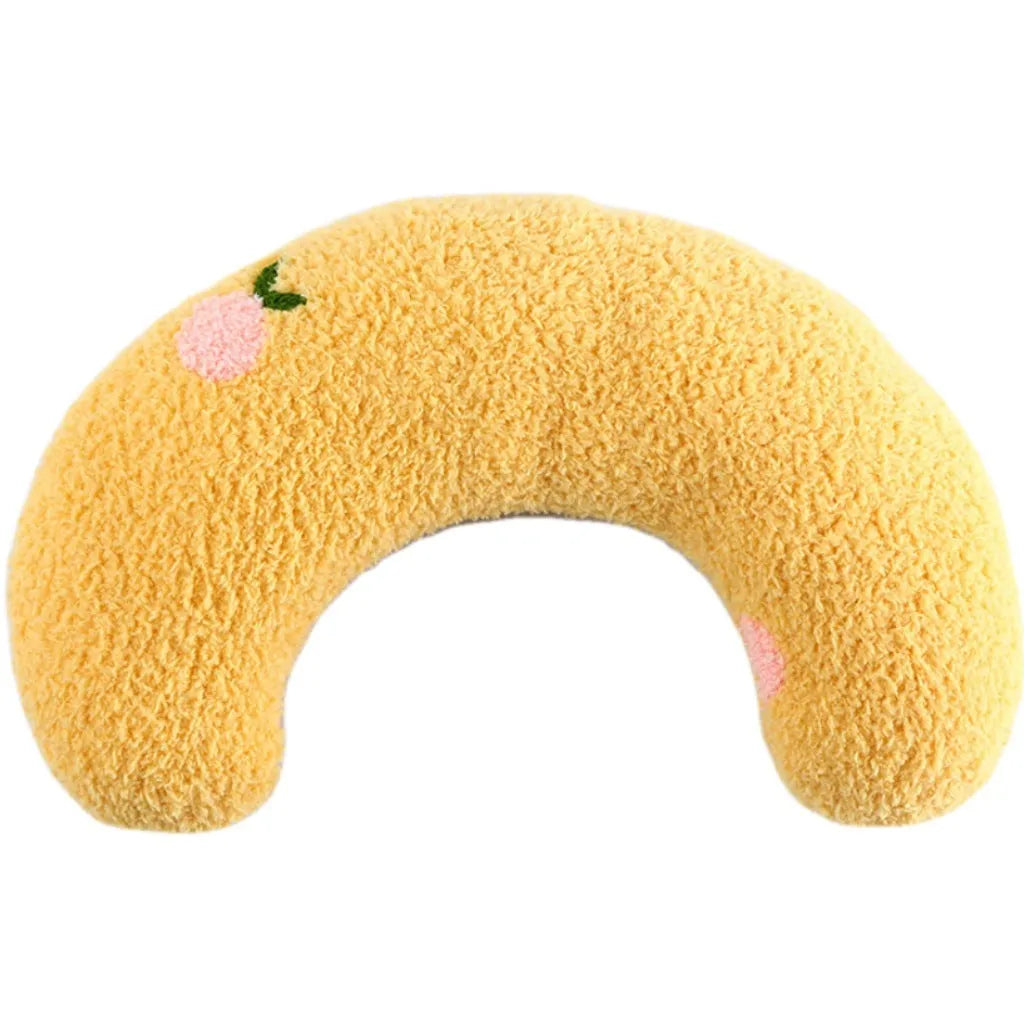 A small blue U-shaped plush pillow for a cat or small dog to sleep in.