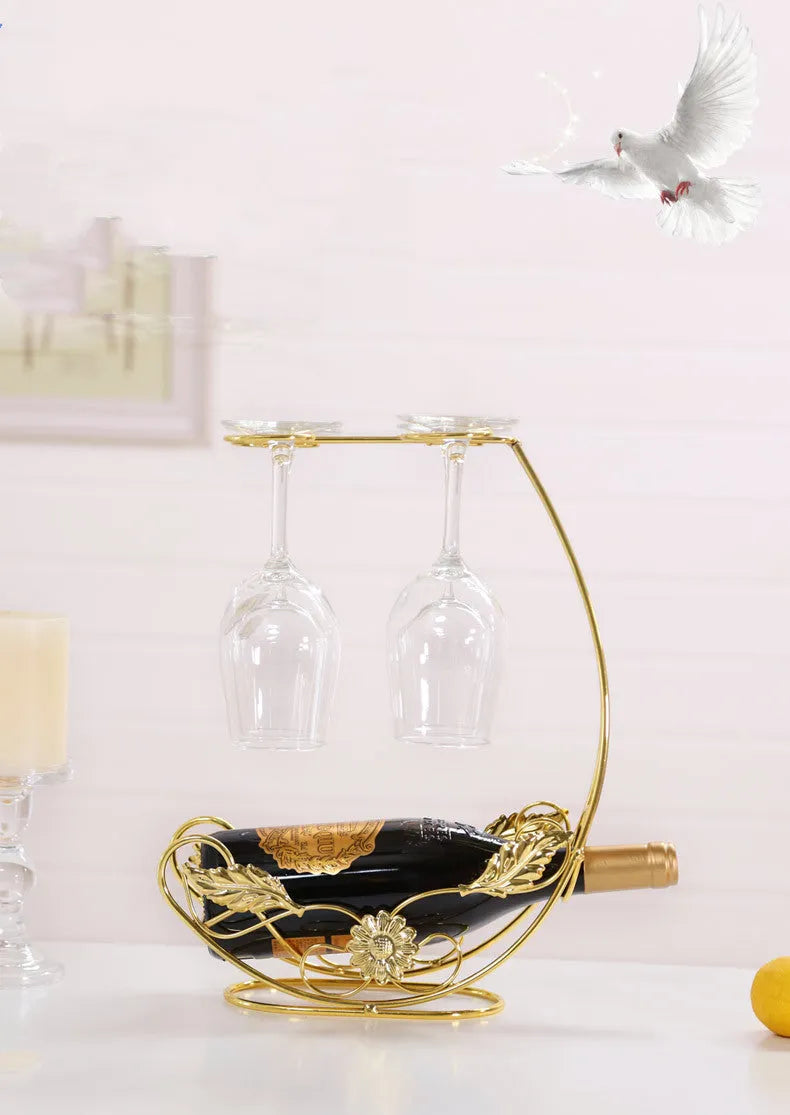 Iron wire goblet shelf holding four wine glasses in bronze finish on a wooden cabinet