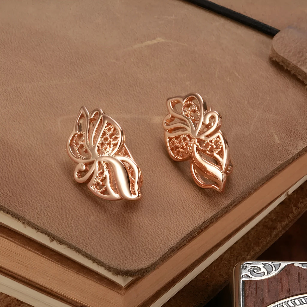 Women's rose gold earrings with hollow carved geometric design and rhinestone accents