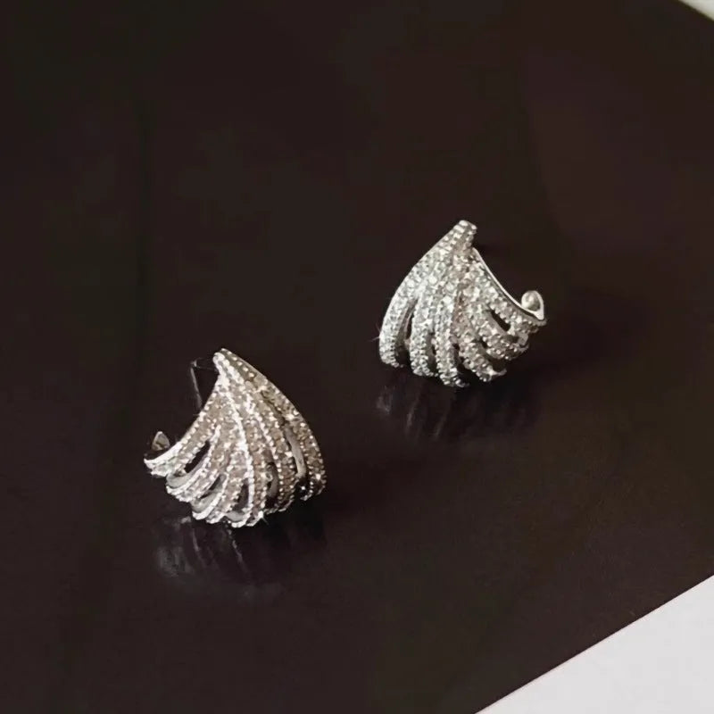 A pair of geometric drop earrings with a platinum electroplated finish on zircon.