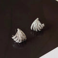 A pair of geometric drop earrings with a platinum electroplated finish on zircon.
