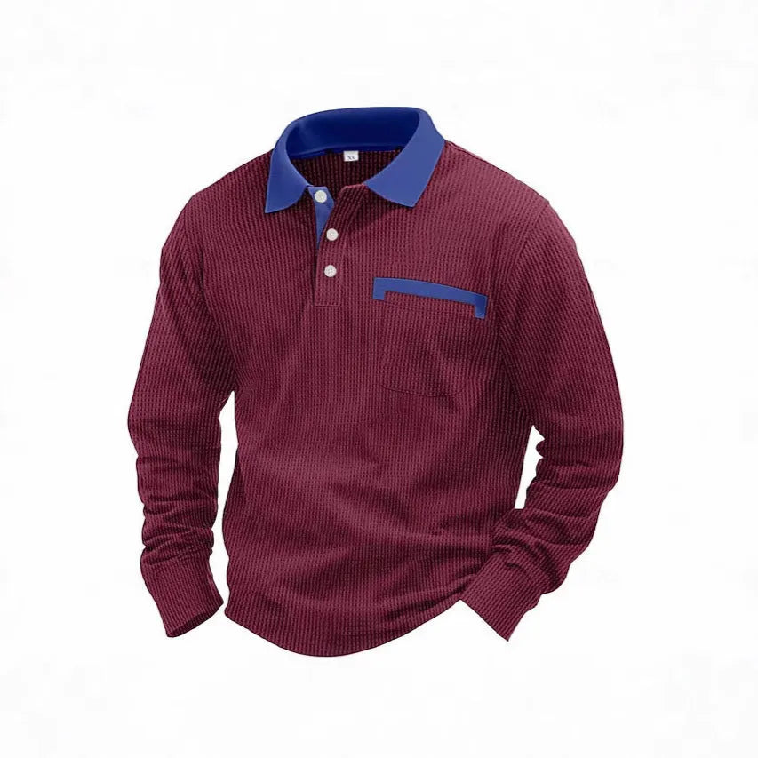 Man wearing a loose-fit long-sleeved waffle-texture polo shirt in a dark colour.