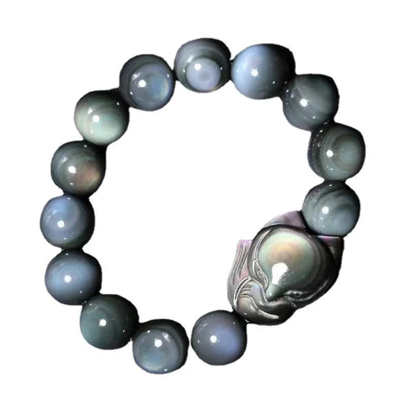 Black obsidian stone bracelet with carved fox design in cartoon style, showing texture and adjustable sizing