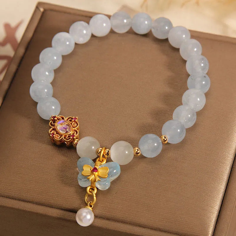 Women's aquamarine butterfly pendant crystal bracelet with rhinestone detailing on wrist