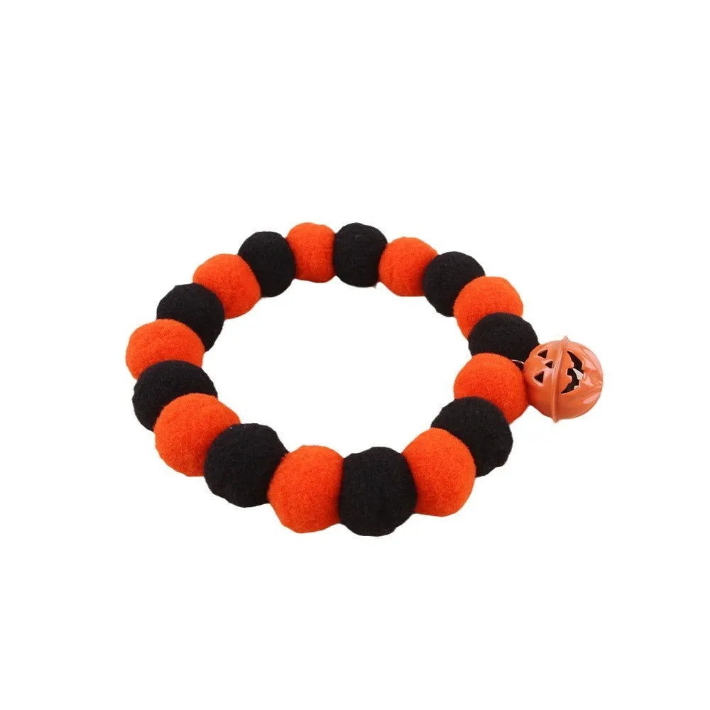 Orange Halloween pet collar with black trick-or-treat pumpkin design on a cat.