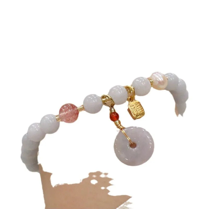 Gold plated women's bracelet with aquamarine chalcedony crystal pendant and floral design.