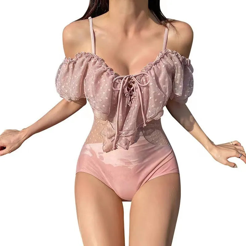 Pink solid colour one-piece swimsuit for women on a hanger