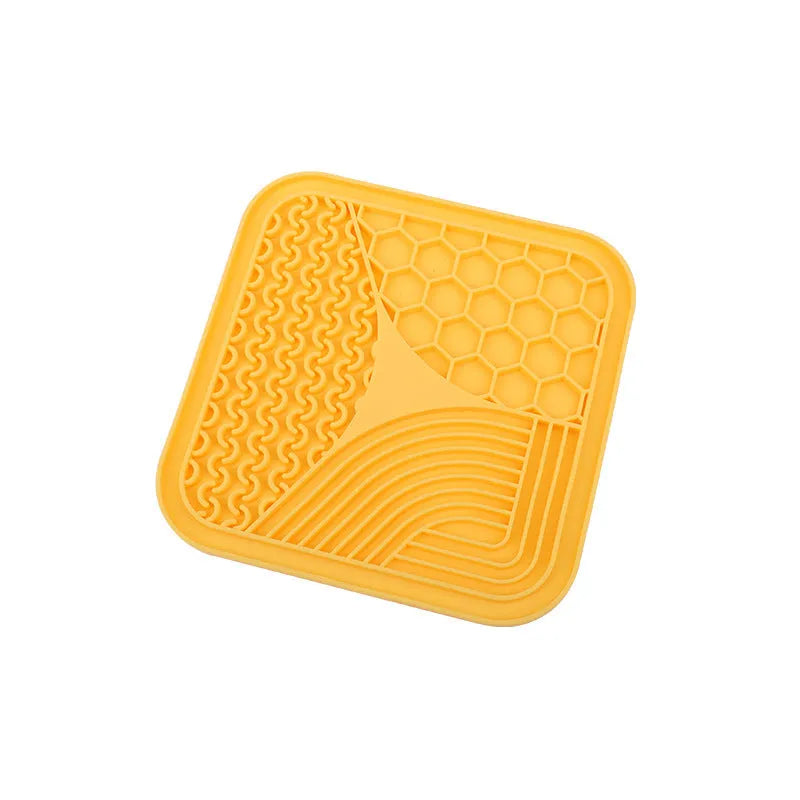 Gray silicone anti-choke slow feeding dog licking pad with textured surface on a flat surface