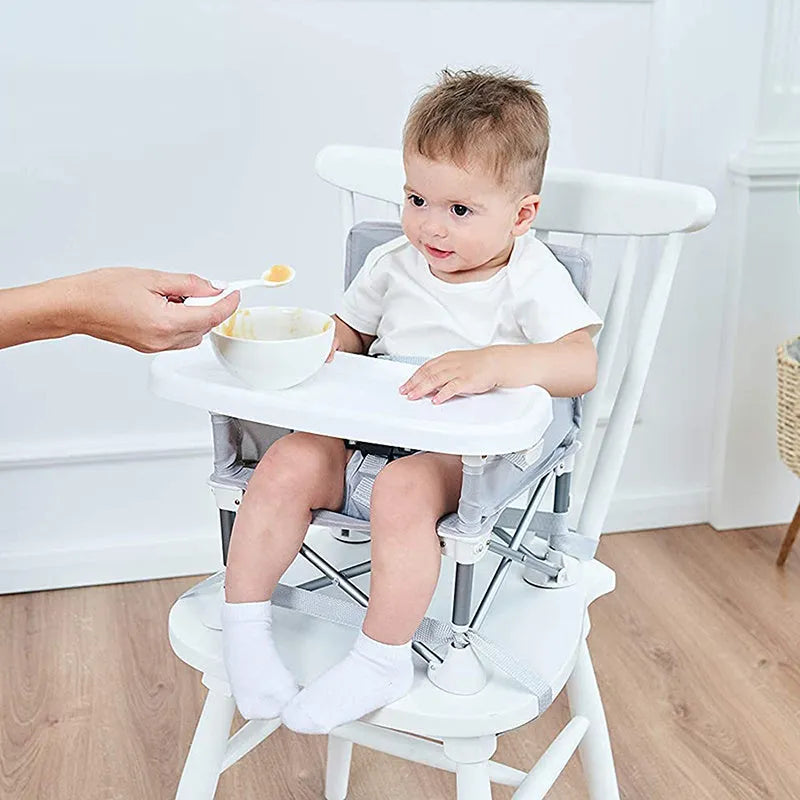 Foldable baby dining chair in folding grey with removable tray and safety belt, includes storage bag
