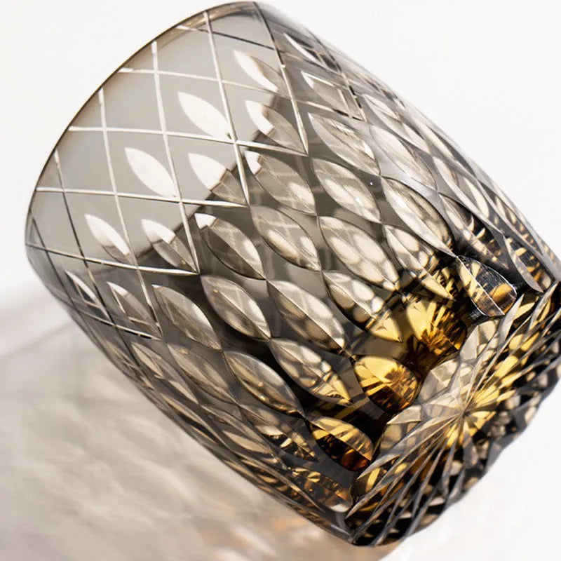 Four Japanese-style Edo crystal glass whisky tumblers in amber and clear cut-glass designs placed in wooden box