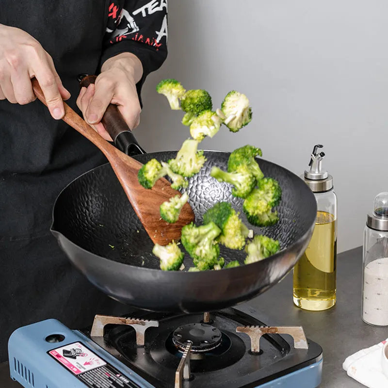 Traditional black iron wok pan with wooden handle measuring 40x32x10cm