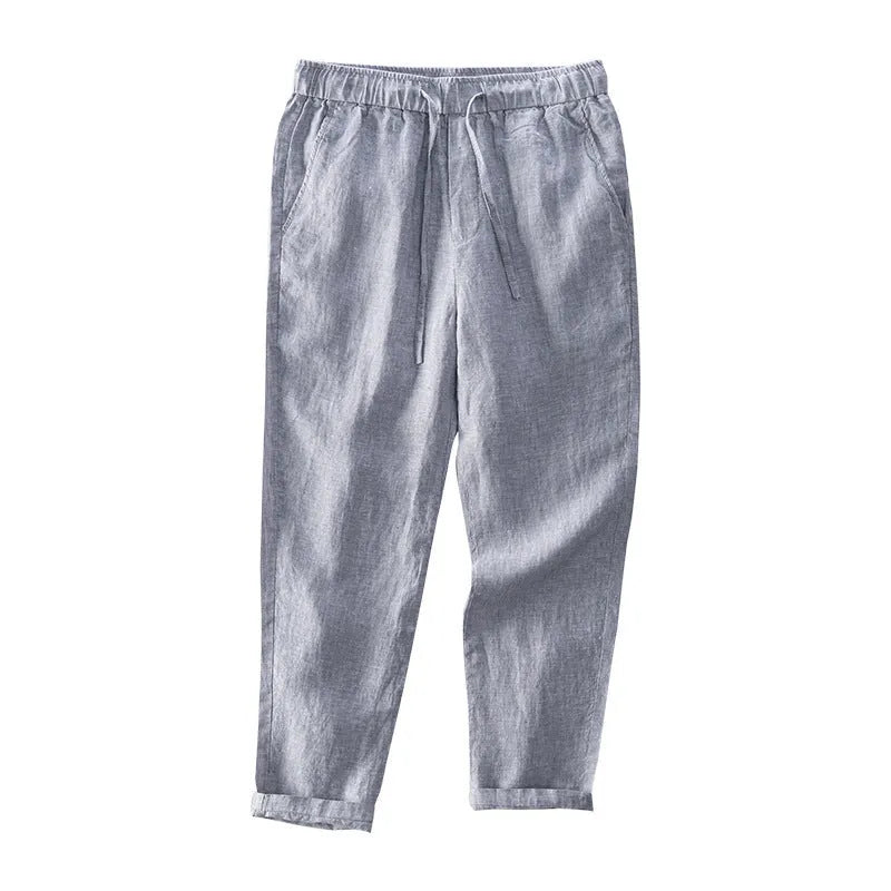 Men's straight-leg linen trousers in dark grey laid flat, showing mid waist and relaxed fit
