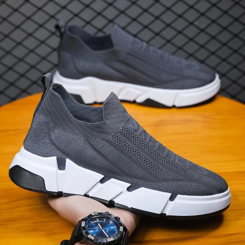 Men's slip-on casual sports shoes with black flyknit mesh upper and sock cuffs, flat PVC sole