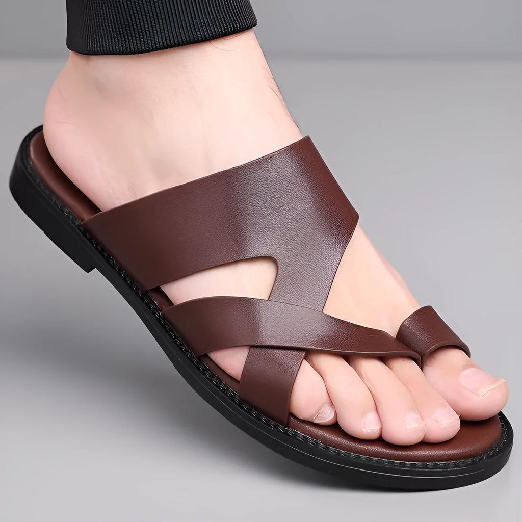 Simple Leisure Seaside Beach Slippers in dark brown with rubber sole, side view on sand