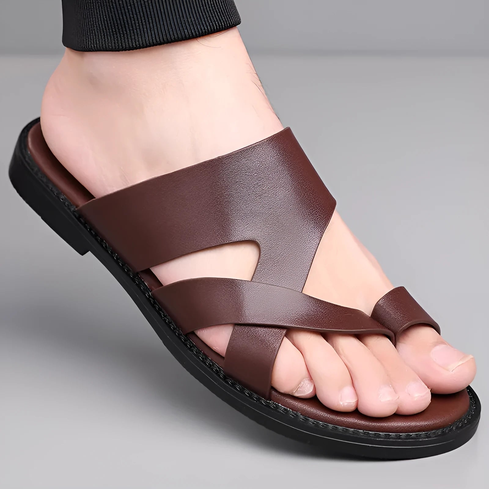 Simple Leisure Seaside Beach Slippers in dark brown with rubber sole, side view on sand