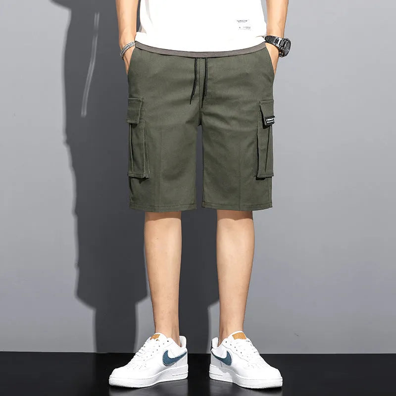 Men's camouflage 5-point workwear shorts in green, front view, with drawstring waist and mid-thigh length