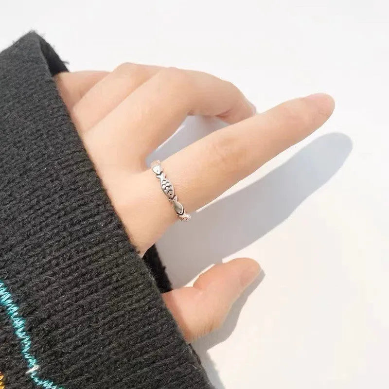Close-up of a women's adjustable S925 sterling silver ring featuring a detailed fish (carp) design.