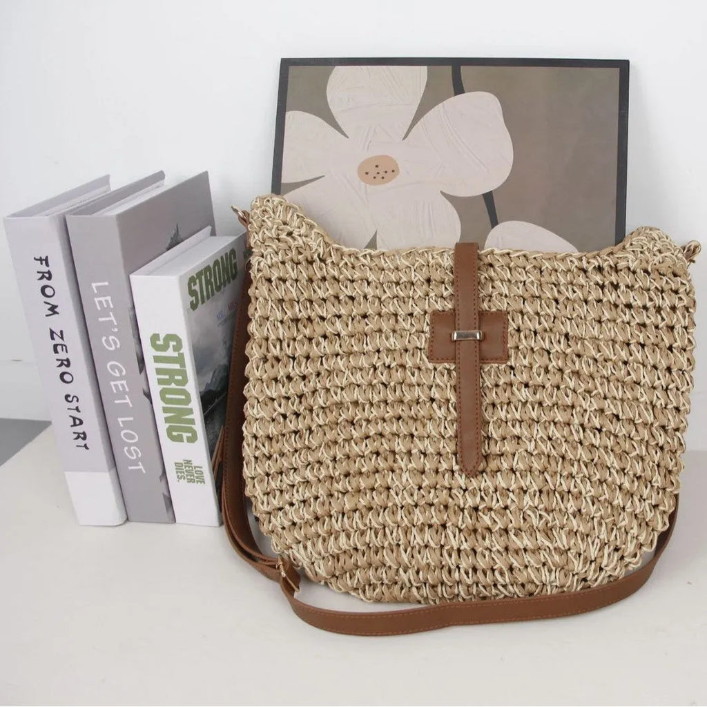 Beige handmade woven bag with a special-interest design and a long shoulder strap.