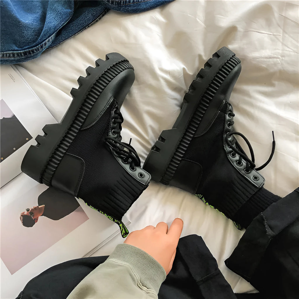 Men's black frosted leather Doc Martens platform boots on a white background, showing both lace-up and zipper style options.