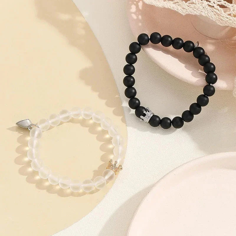 Luminous glow-in-the-dark crown bracelet set in white and black colors, showcasing a unique design and enchanting nighttime glow