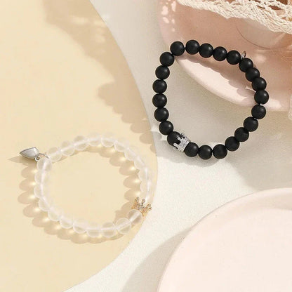 Luminous glow-in-the-dark crown bracelet set in white and black colors, showcasing a unique design and enchanting nighttime glow