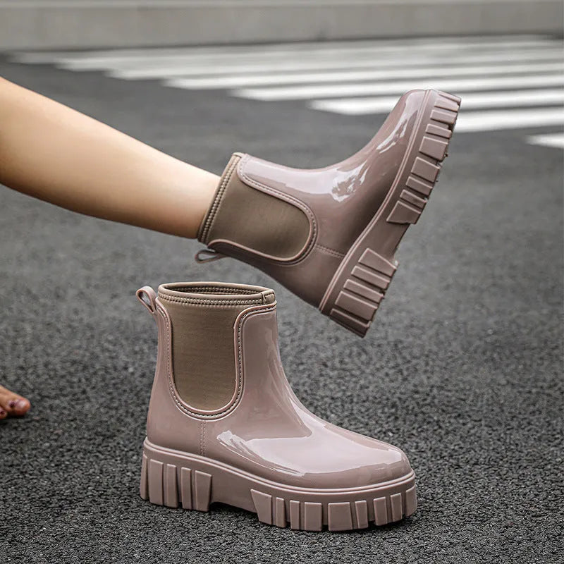 PVC low tube rain boot in solid colour with flat heel and non-slip sole.