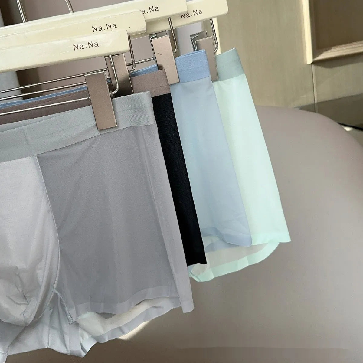 Ultra-thin Ice Silk seamless men's boxer shorts on a mid waist, showing honeycomb crotch detail.