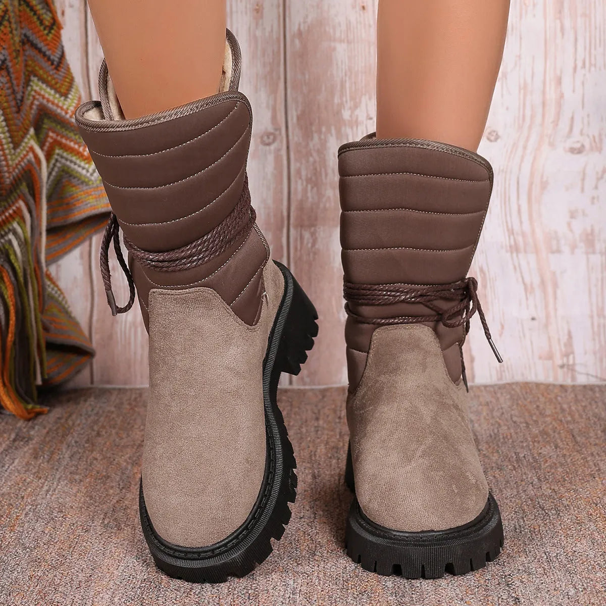 Black women's chunky heel snow boots with lace-up design and suede upper on a rubber sole
