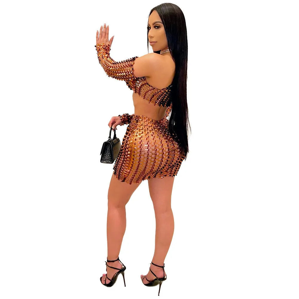Women's black hollow-out net top and matching short skirt two-piece set on a model.