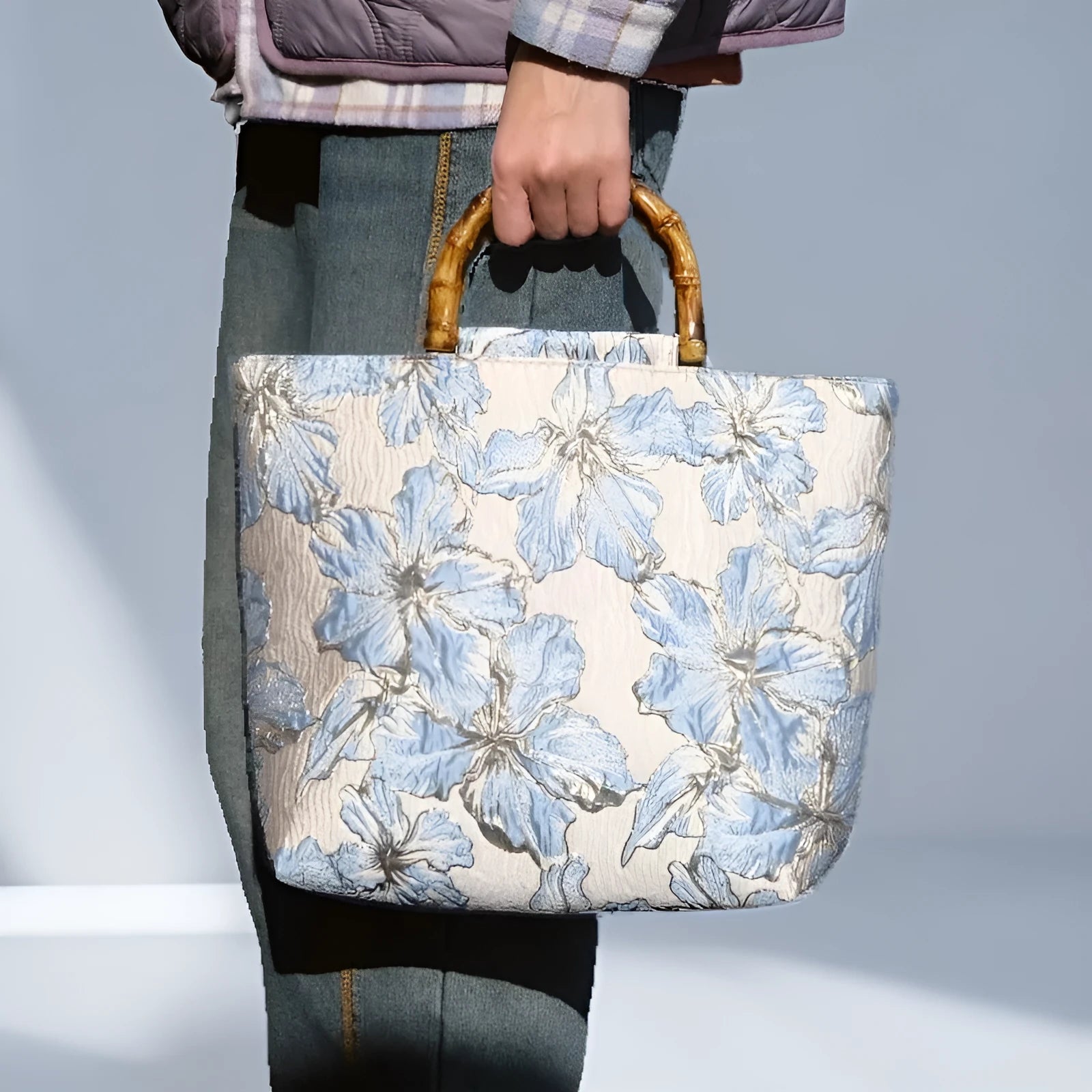 Light blue canvas bag with gold floral pattern showing double shoulder straps and square 30cm shape