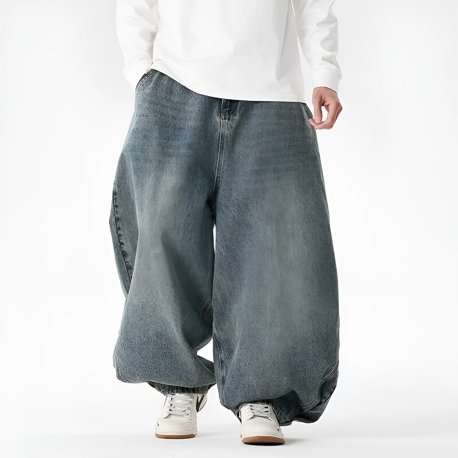 Men's plus-size light blue wide-leg denim jeans with a loose, baggy fit and straight legs on a hanger.