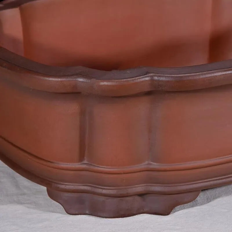 Large antique finish purple clay flowerpot with carved tree stump design featuring pine, cypress, pomegranate, golden marble and crabapple motifs