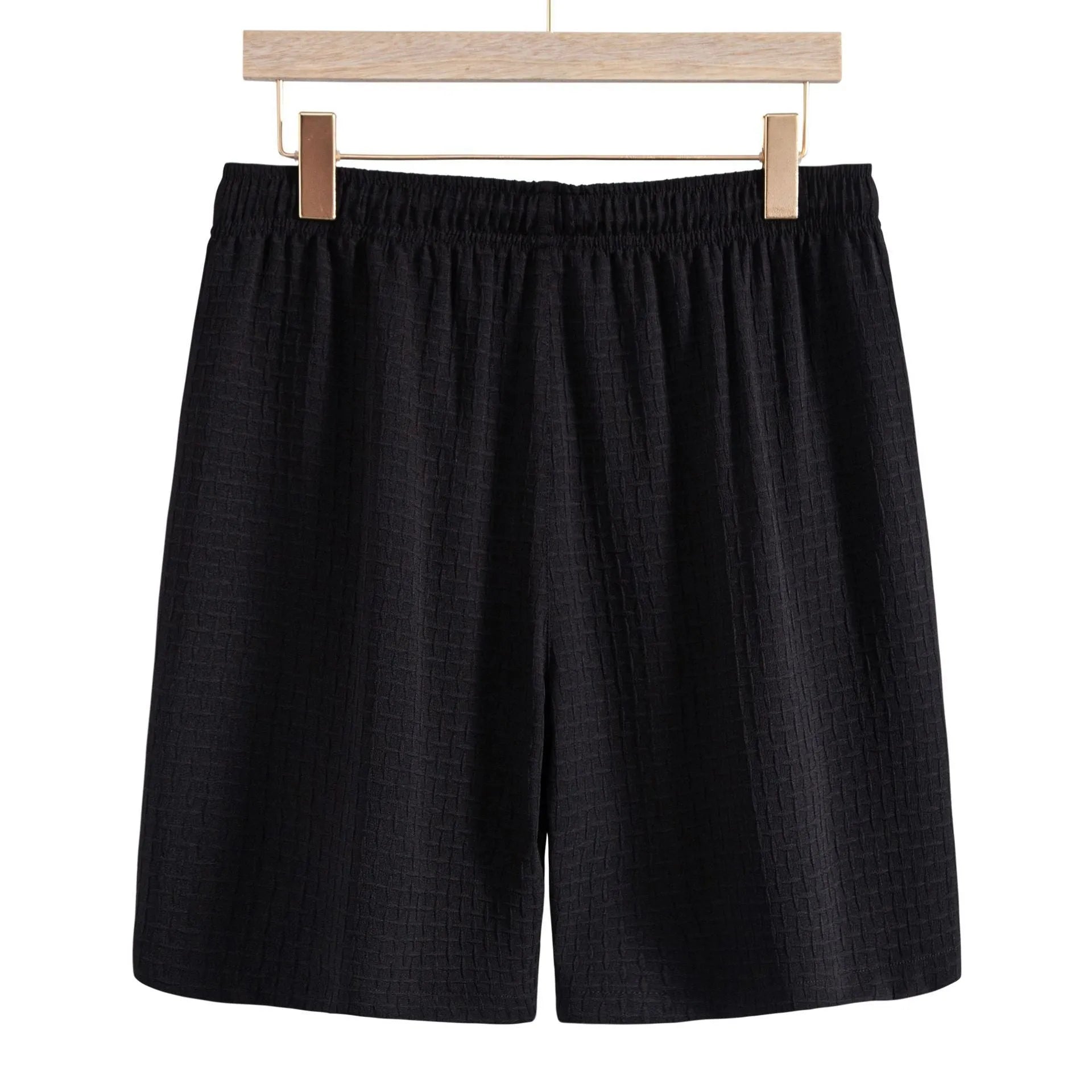 Men's black cotton blend short sleeve shirt and matching shorts casual suit laid flat.