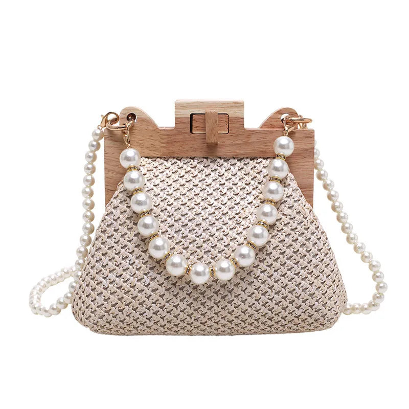 Women's woven straw shoulder bag with pearl chain detail, shown in beige, featuring internal organiser pockets.
