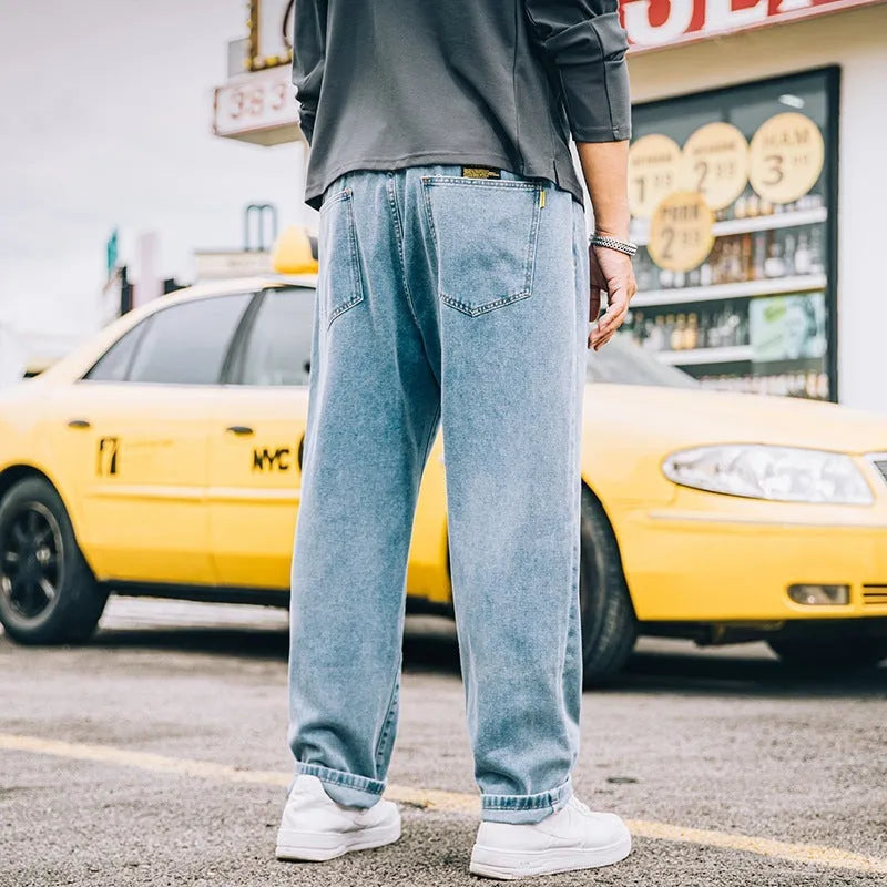 Men's loose straight jeans in dark blue, light blue and grey colours showing simple casual style