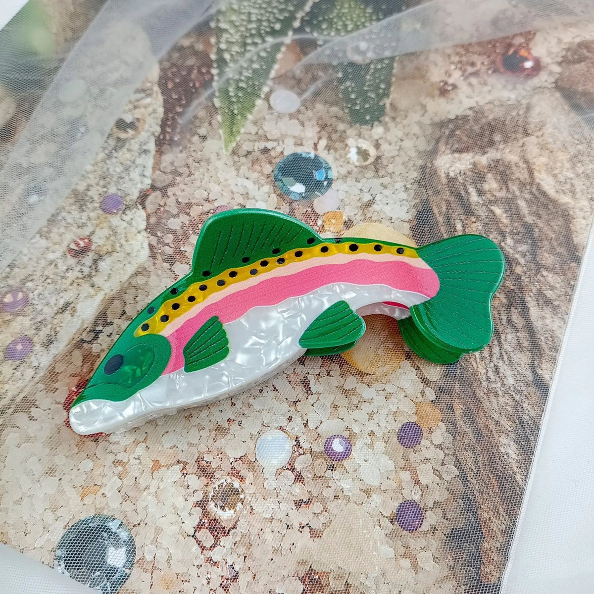 Dark green women's hair clip with detailed printed rainbow trout and carp marine design