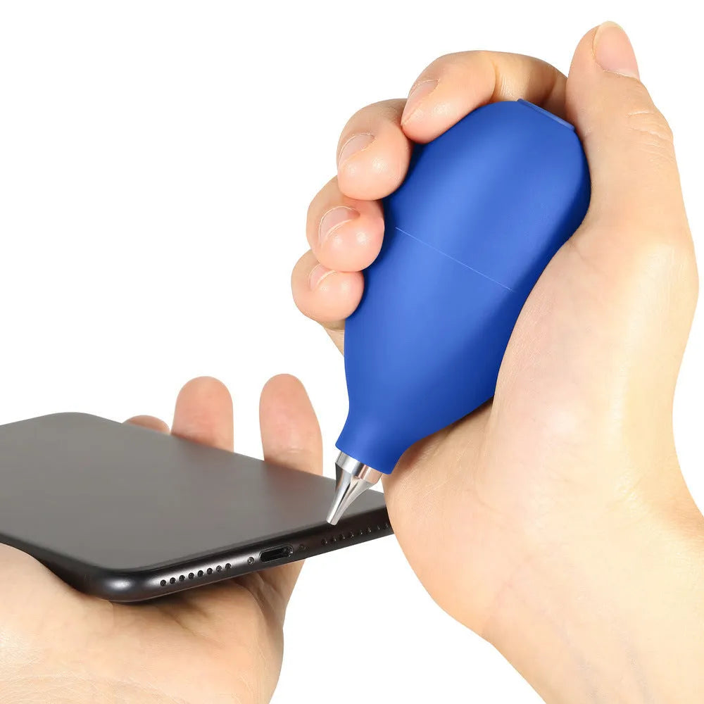 Blue rubber dust removal air blower cleaning tool shown next to a mobile phone.