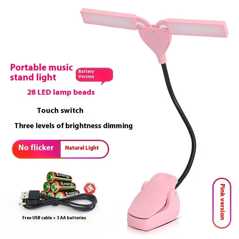 Black plastic music stand lamp with 28 LED lights and a USB charging cable on a music stand.