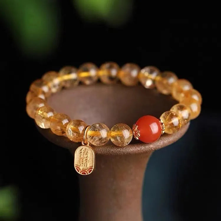 Red agate lucky bead bracelet with gold ruby accents showing polished natural stone beads