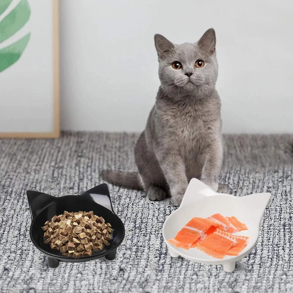 Black shallow cat food bowl with non-slip rubber base on kitchen floor