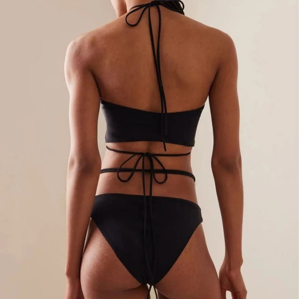 Women's black lace-up bikini swimsuit with separate bra and shorts on mannequin
