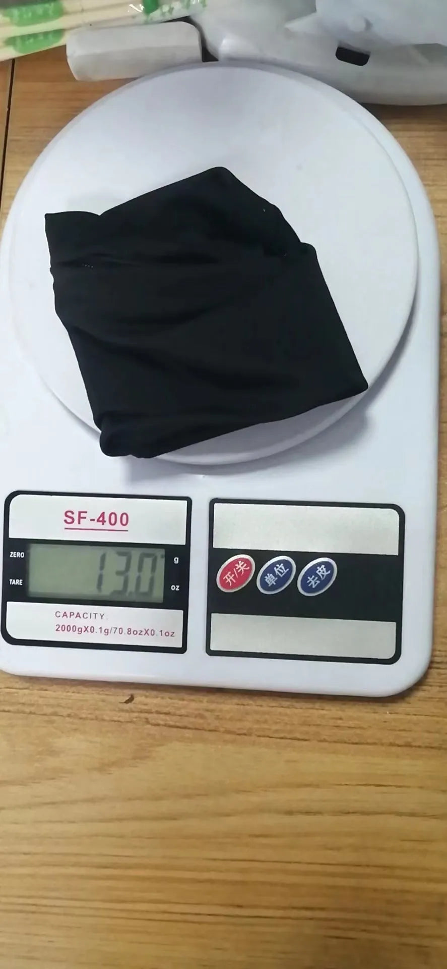 Compact 10 by 10.5 cm black armband sleeve for mobile phone, shown with packaging.