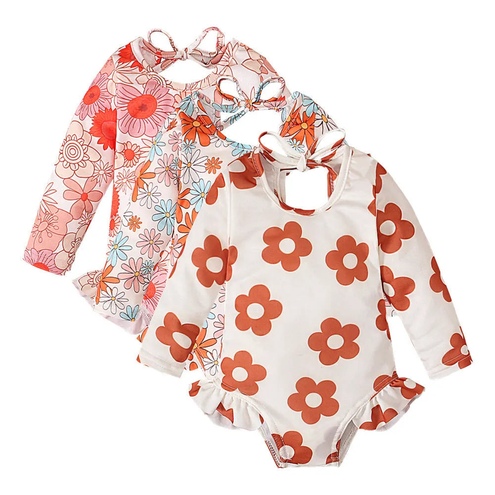 Girl's floral print swimsuit with crew neckline and open back design in orange colour