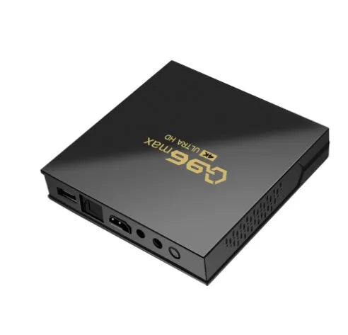 Q96 MAX S905 Android 4K TV Box streaming media player with remote control and accessories on a wooden table.