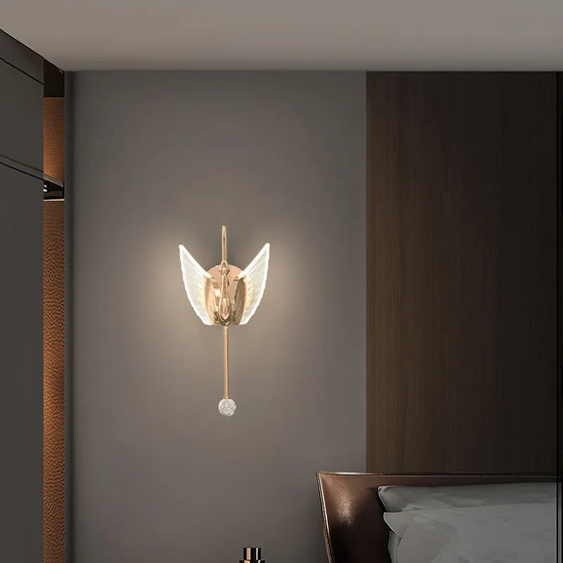 Modern minimalist gold swan-shaped wall lamp with an acrylic shade and LED light.