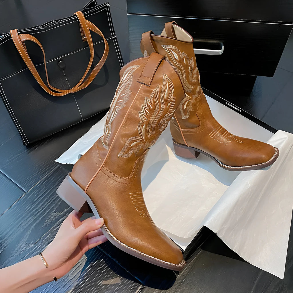 Brown leather women's mid-calf Martin boots with embroidered totem pattern and a waterproof platform sole.